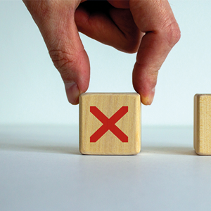 hand takes a dice with a red cross